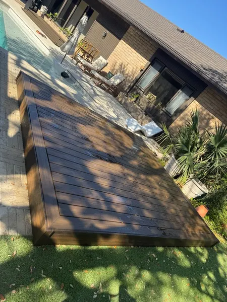 Poolside view of a custom floating hardwood deck — CertiPro project