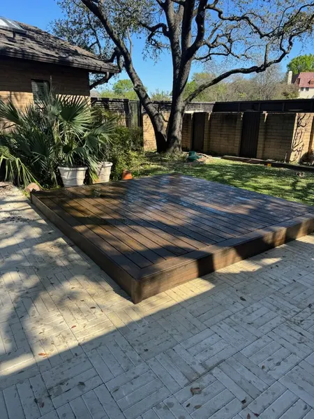 Floating hardwood deck platform in a landscaped DFW backyard — CertiPro project
