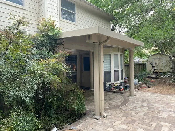 Angled view of a completed entrance patio cover and paver patio extension — CertiPro project, DFW