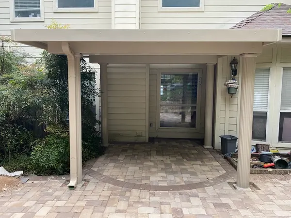 Finished entrance patio cover with fluted columns over a new circular paver patio — CertiPro project