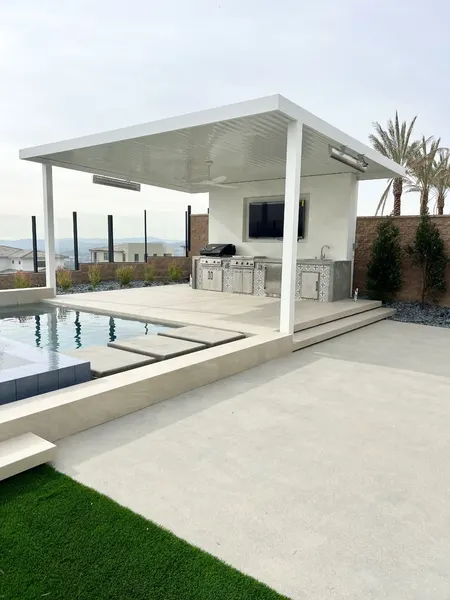 Poolside cabana with outdoor kitchen, TV wall, and ceiling fan — CertiPro project