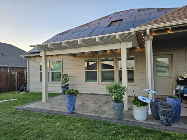 Full view of a custom lattice patio cover spanning the back of a DFW home — CertiPro project