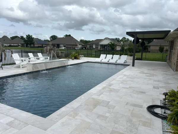 Backyard pool with fountains and an attached patio cover extension — CertiPro project