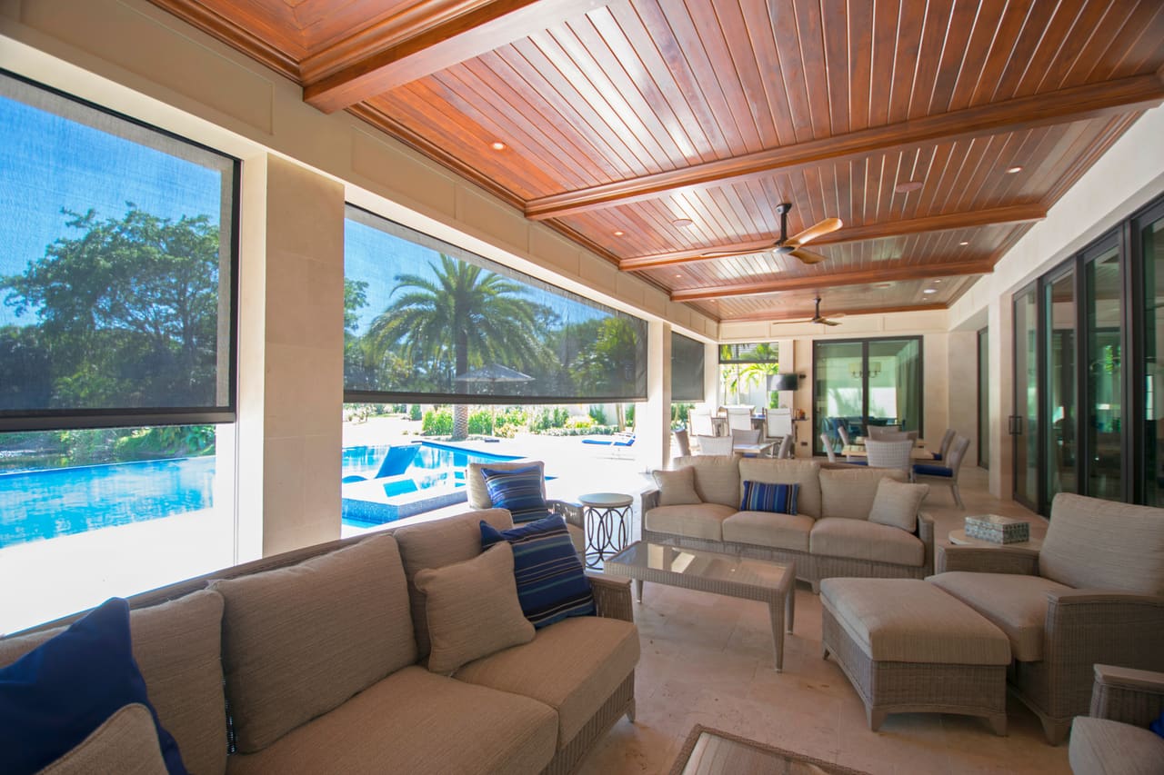MaxForce™ Hurricane Screens partly lowered on a covered patio